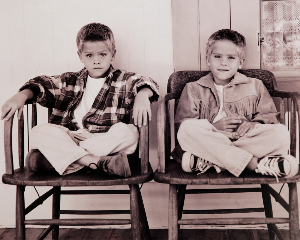 Twin boys sitting on chairs